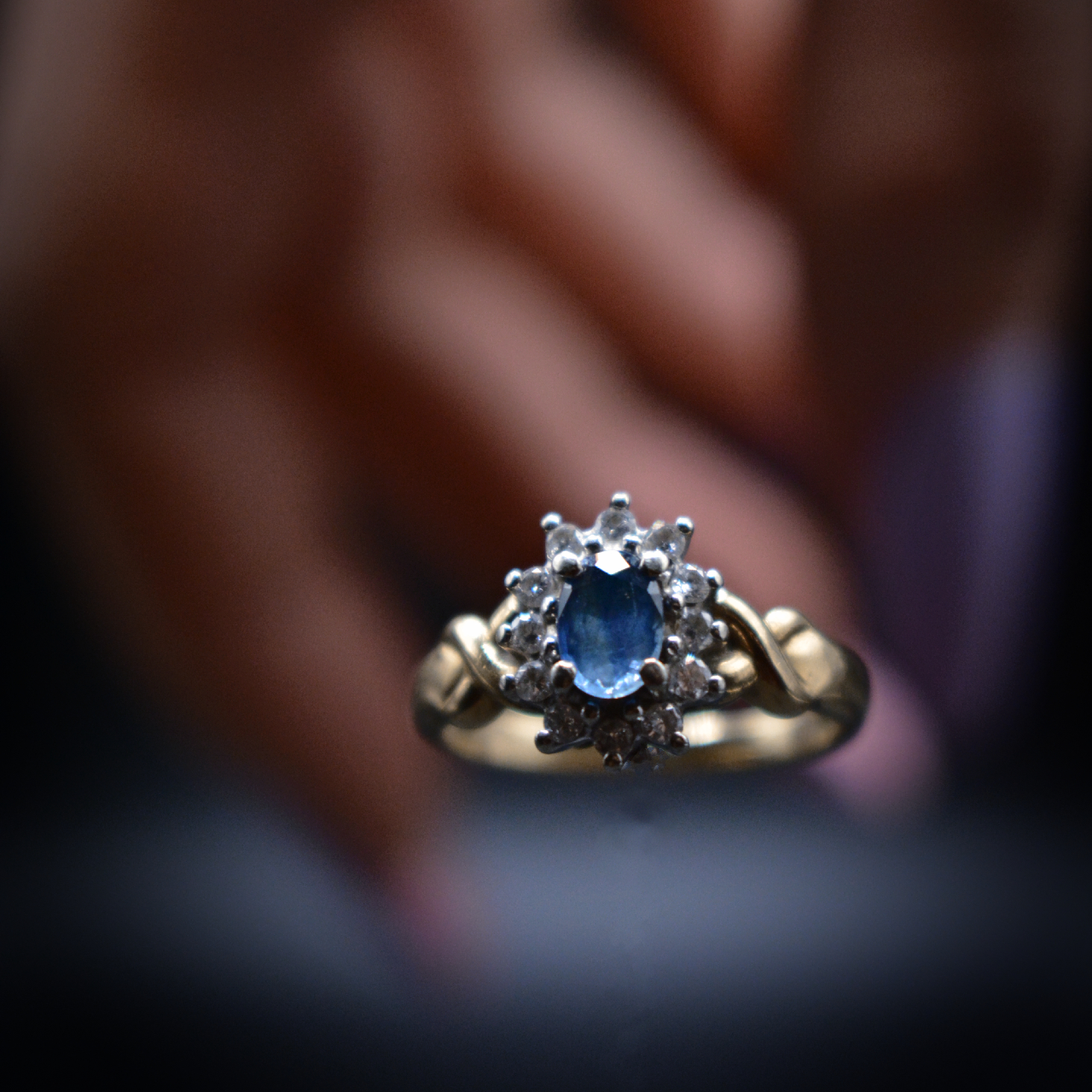 Cluster Gold Ring- Saphire main stone and Diamonds with faded hand behind - Lumiuk