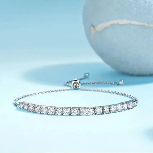 Sterling Silver Chain Bracelet with light blue background with  a blue tennis ball in the background