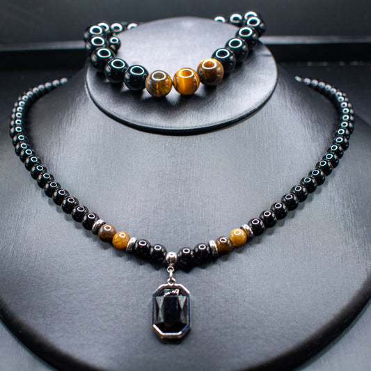 Necklace with pendant and bracelet on a dark surface